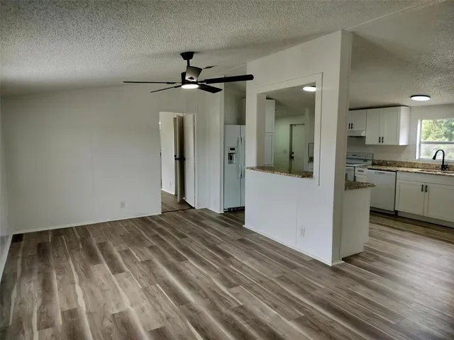 a view of a kitchen with a sink and cabinets