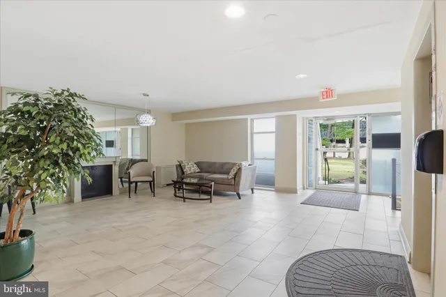 a lobby with furniture and potted plants