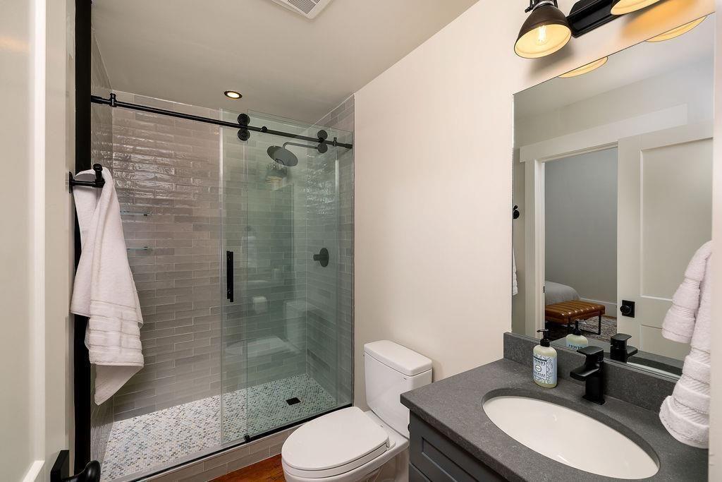 200 J Barrett Street, Unit 305 Monroe, GA 30655 - Photo 5 of 18 a bathroom with a sink toilet a mirror and shower