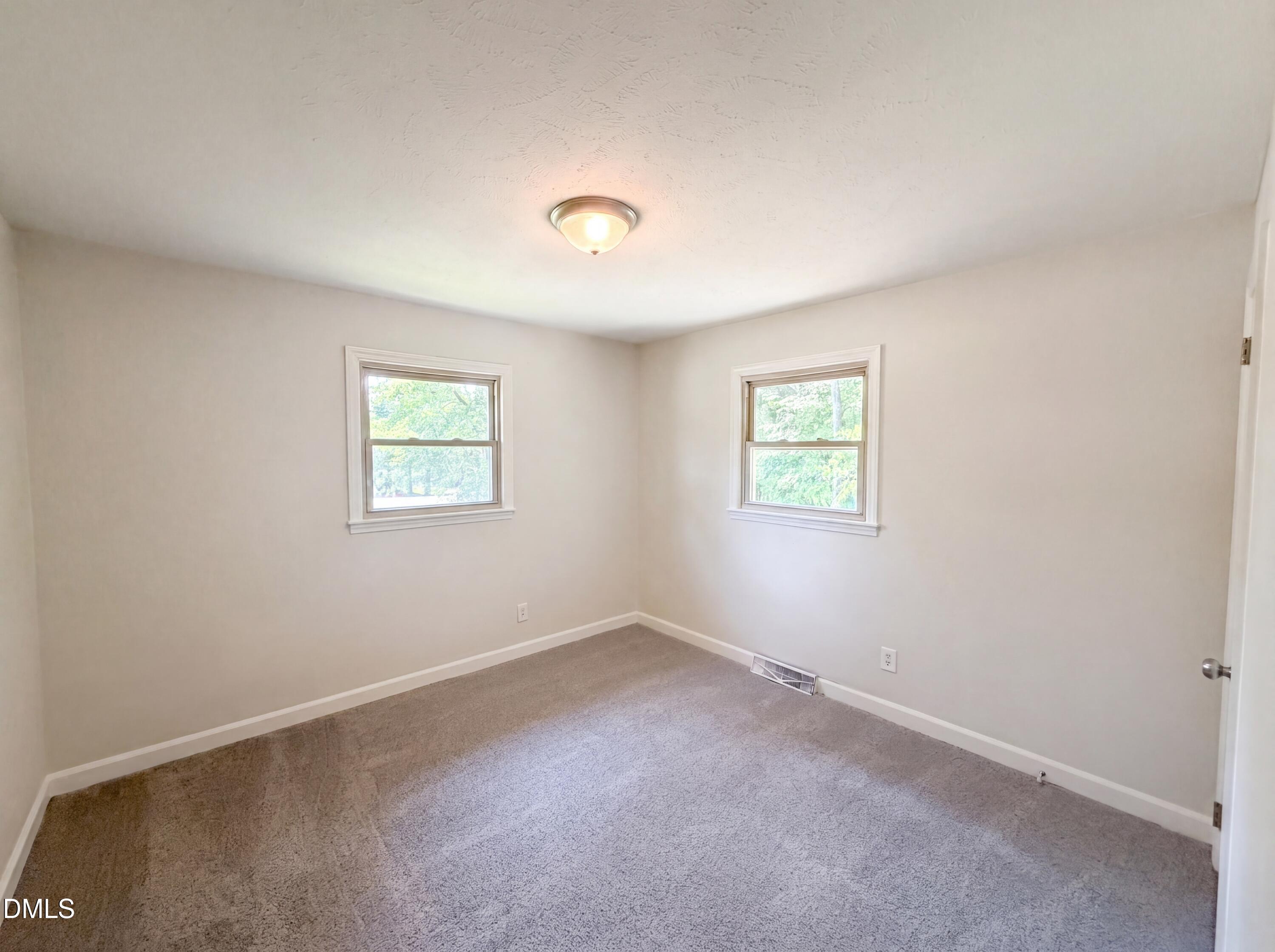 1710 West B Street Butner, NC 27509 - Photo 7 of 14 an empty room with windows