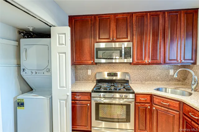 a kitchen with appliances a sink and cabinets