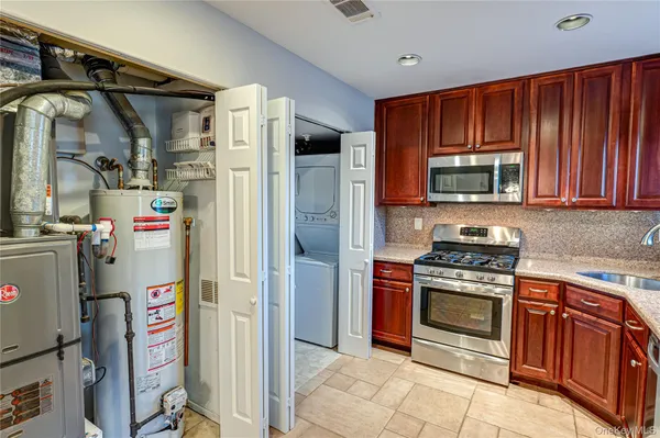 a kitchen with stainless steel appliances granite countertop a refrigerator and a stove top oven