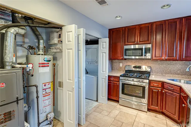 a kitchen with stainless steel appliances granite countertop a refrigerator and a stove top oven