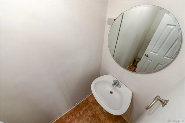 a bathroom with a sink mirror and toilet