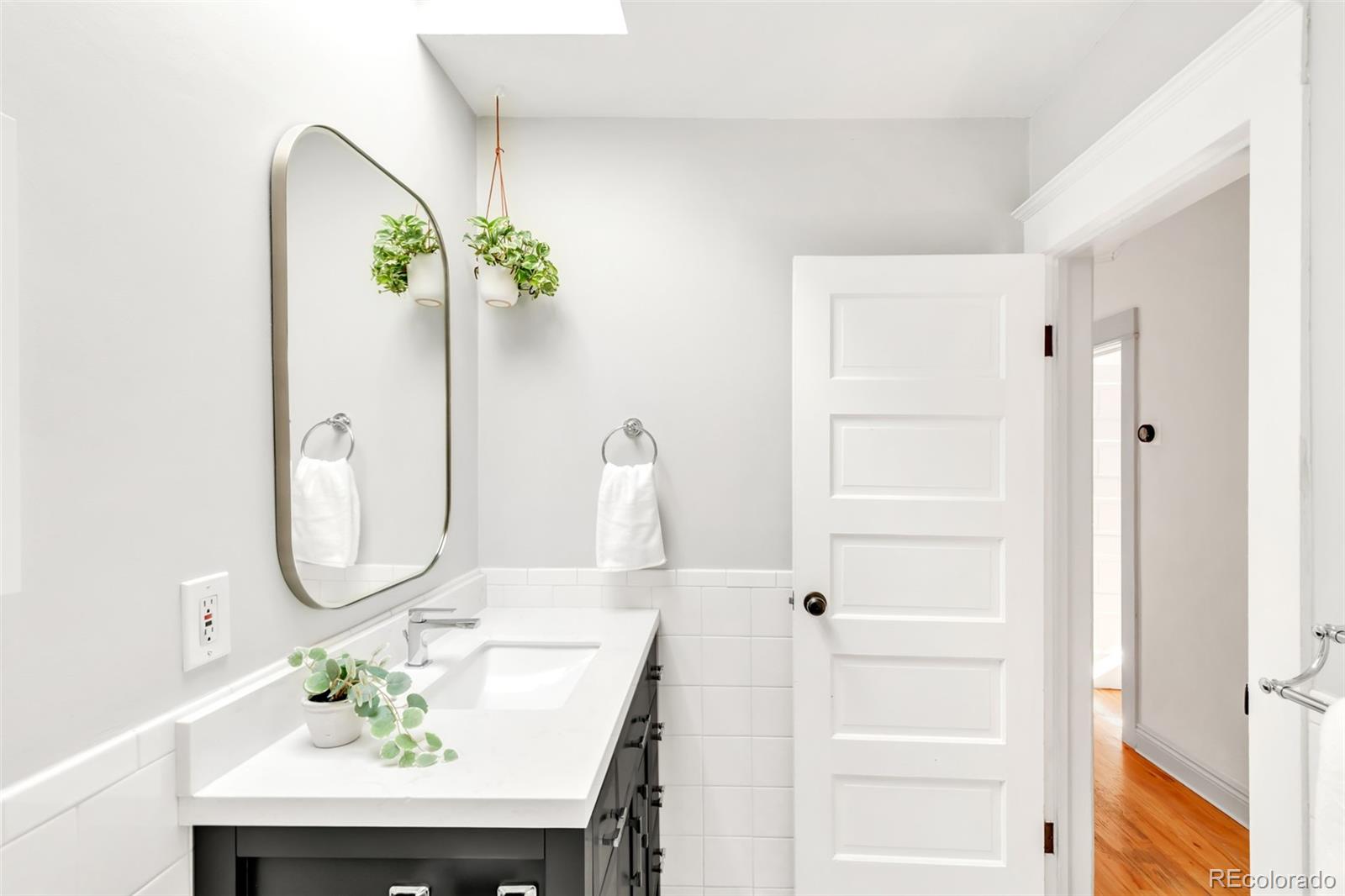 3244 Clay Street Denver, CO 80211 - Photo 15 of 28 a bathroom with a sink a mirror and a shower with a mirror
