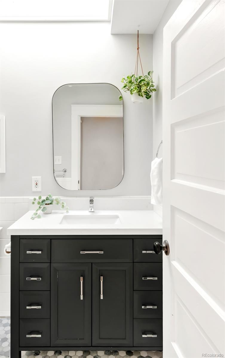 3244 Clay Street Denver, CO 80211 - Photo 16 of 28 a bathroom with a sink vanity and a mirror