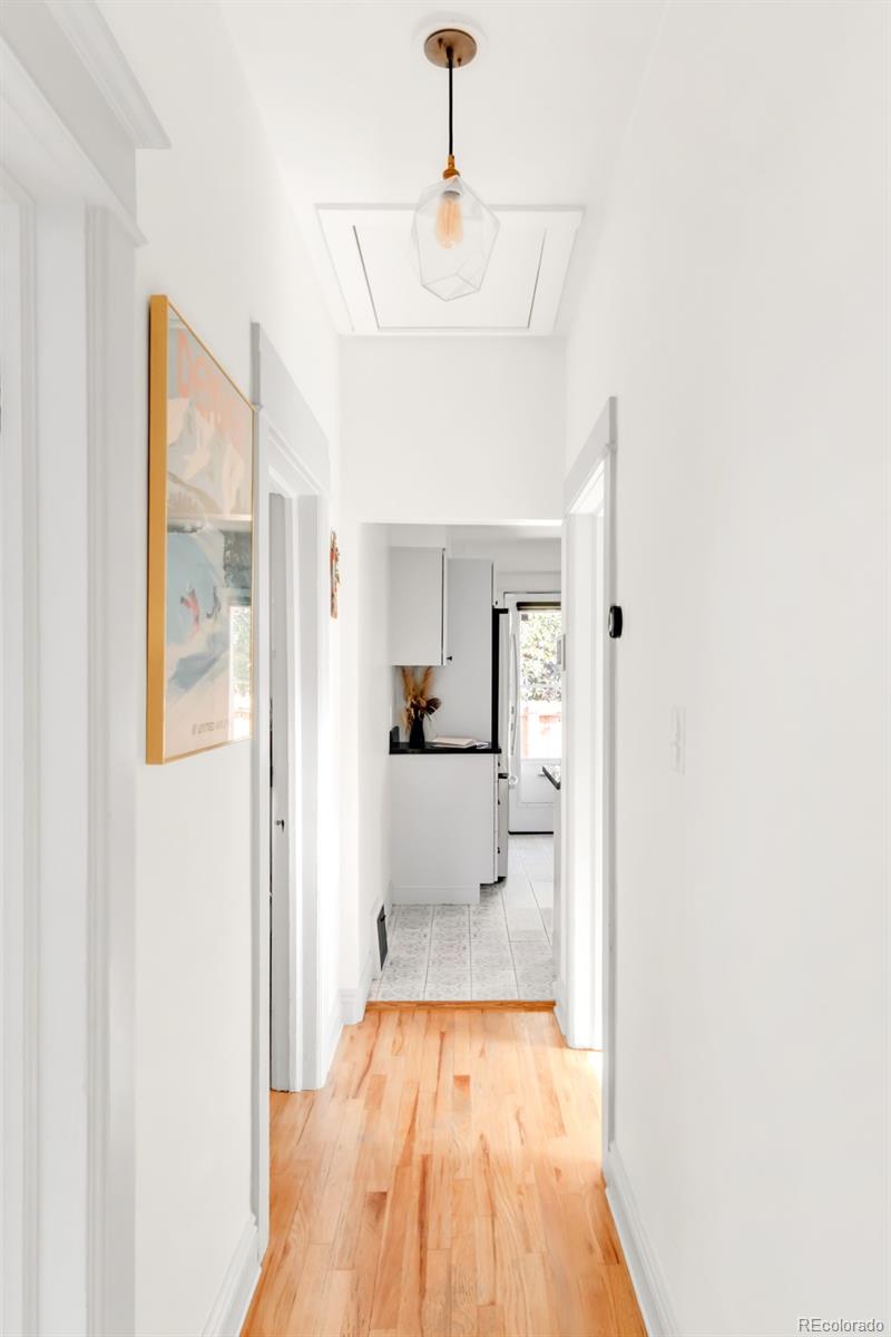 3244 Clay Street Denver, CO 80211 - Photo 10 of 28 a view of a hallway with wooden floor and a living room