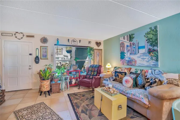 a living room with furniture and a potted plant