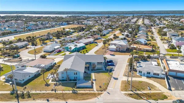 an aerial view of a residential apartment building with a yard
