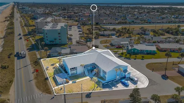 an aerial view of a house with a swimming pool