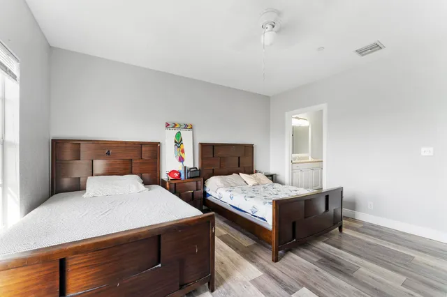 a bathroom with a granite countertop sink a toilet and a mirror