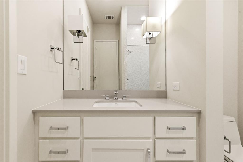 6523 Northwood Road Dallas, TX 75225 - Photo 28 of 36 a bathroom with a sink vanity and a mirror