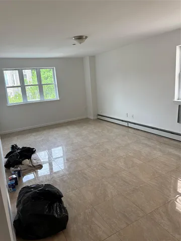 a view of a livingroom with an empty space and a window