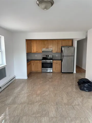 a kitchen with a refrigerator and a stove top oven