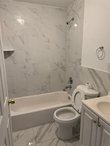 a bathroom with a toilet bathtub and sink