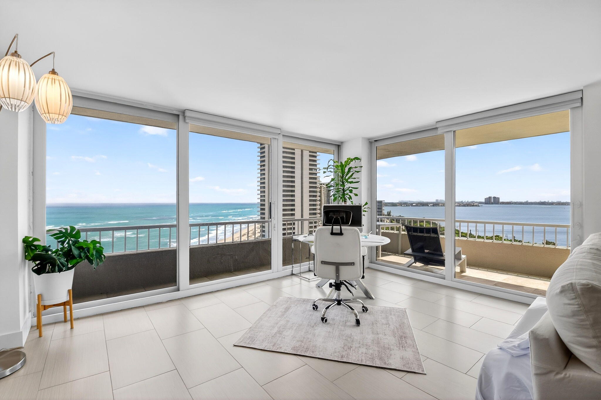 a living room with furniture and floor to ceiling window
