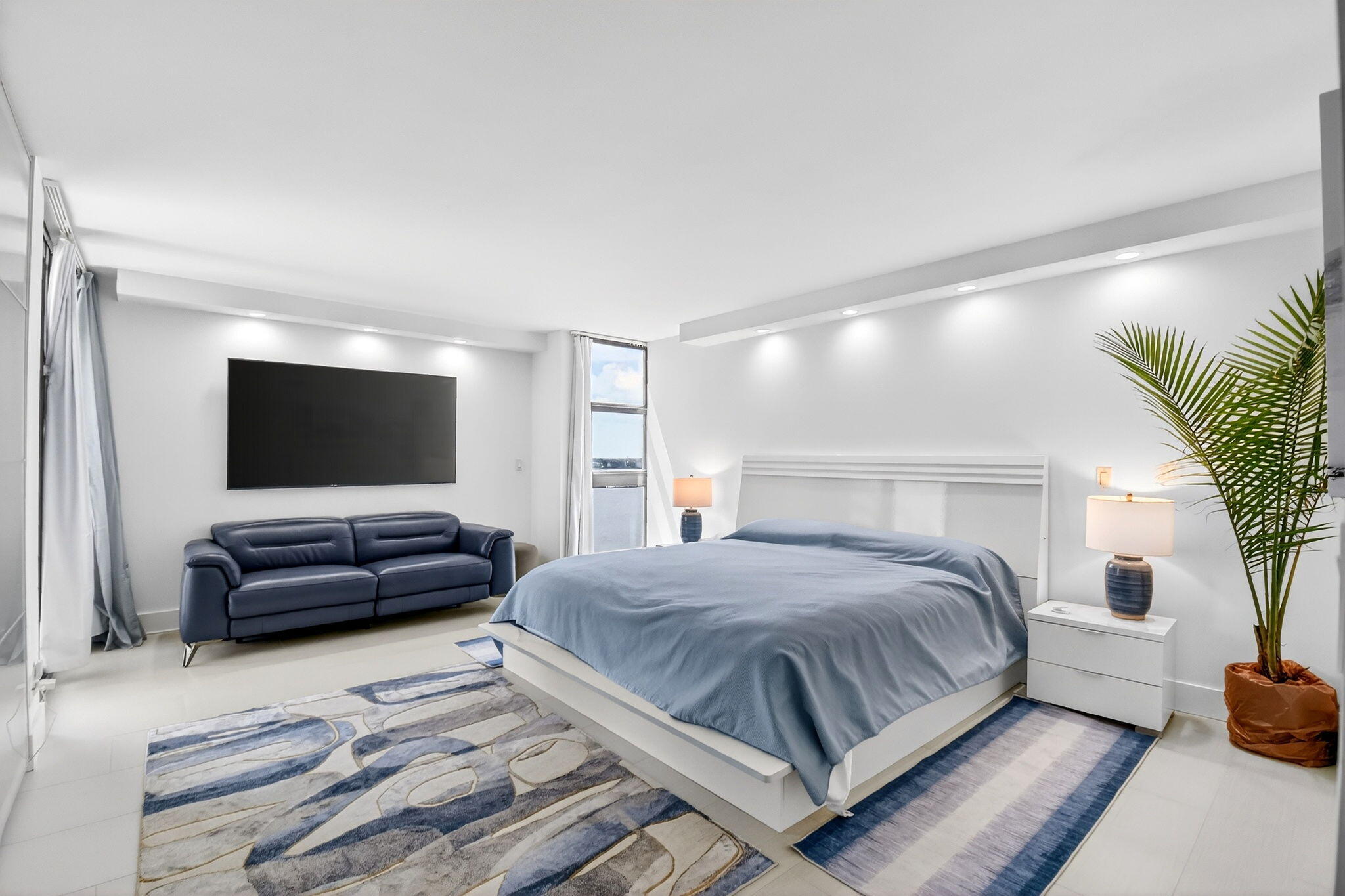 5540 North Ocean Drive, Unit 9B Singer Island, FL 33404 - Photo 12 of 57 a bedroom with a bed and a couch
