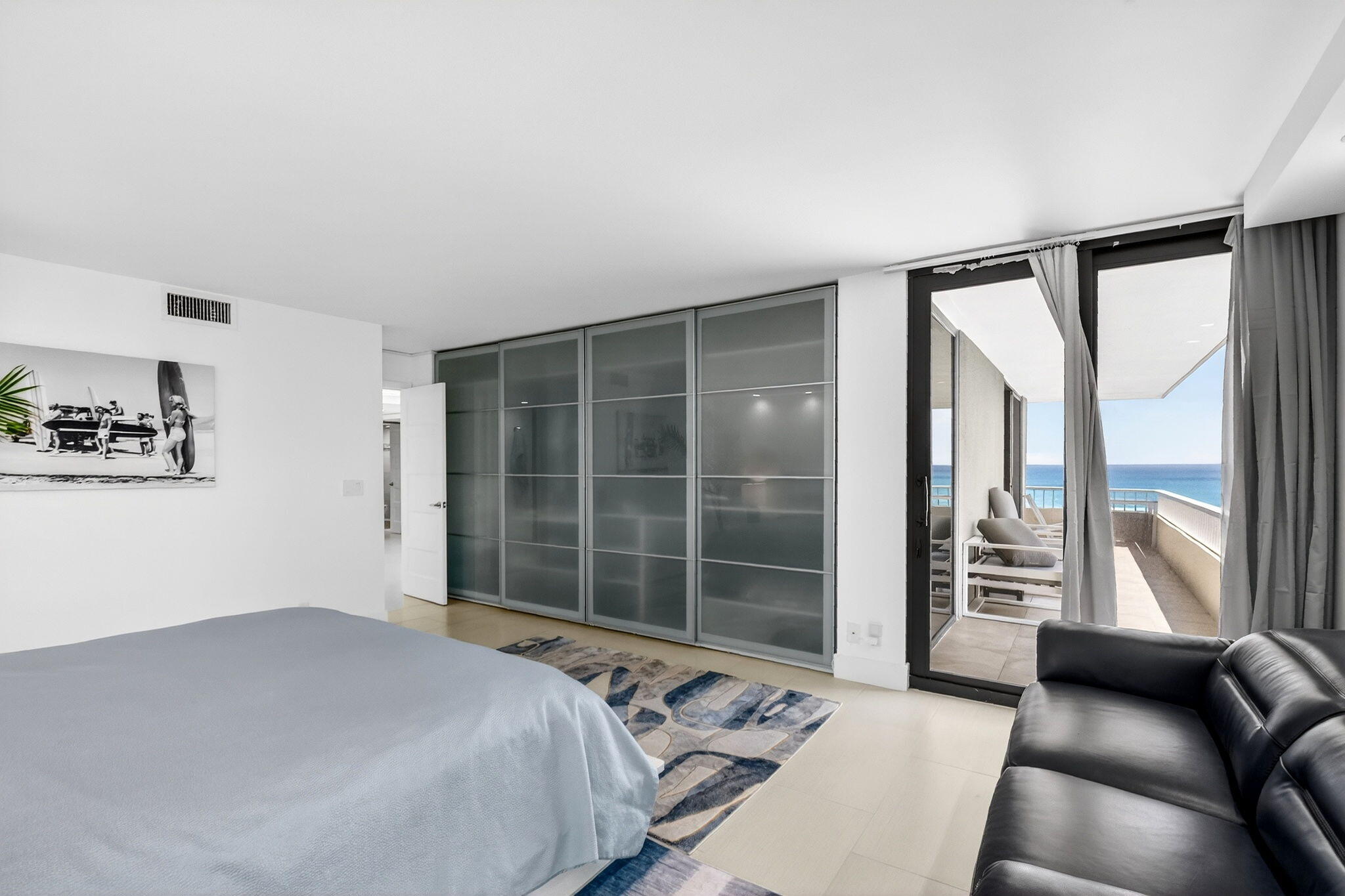 5540 North Ocean Drive, Unit 9B Singer Island, FL 33404 - Photo 13 of 57 a bedroom with a large bed and a large window