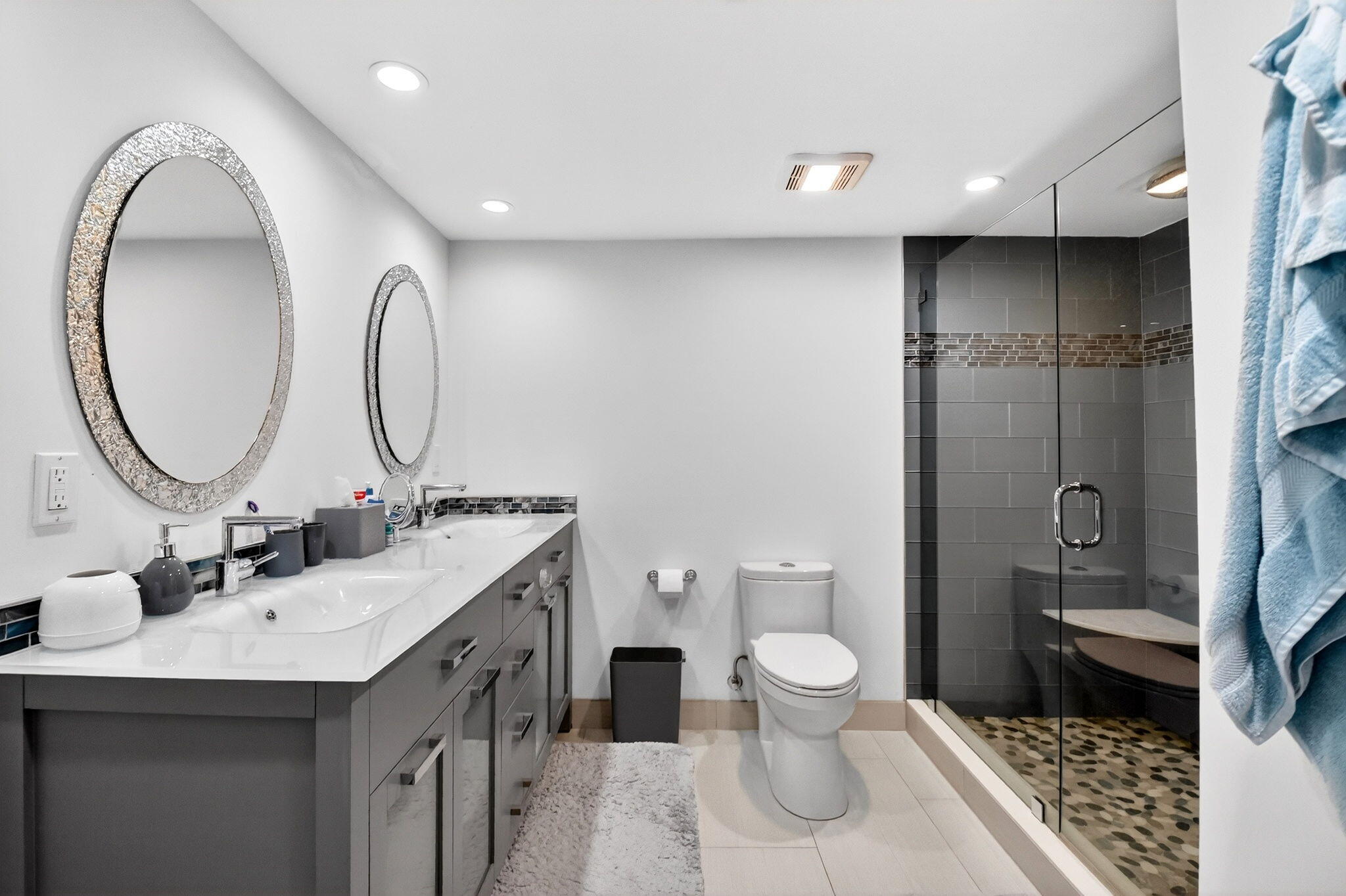 5540 North Ocean Drive, Unit 9B Singer Island, FL 33404 - Photo 15 of 57 a spacious bathroom with a double vanity sink toilet and a mirror