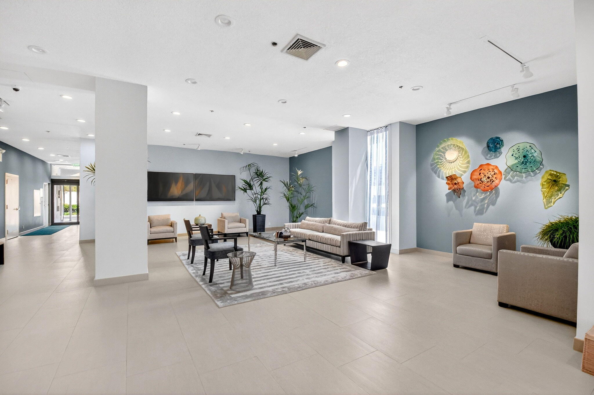 5540 North Ocean Drive, Unit 9B Singer Island, FL 33404 - Photo 20 of 57 a living room with furniture and a flat screen tv