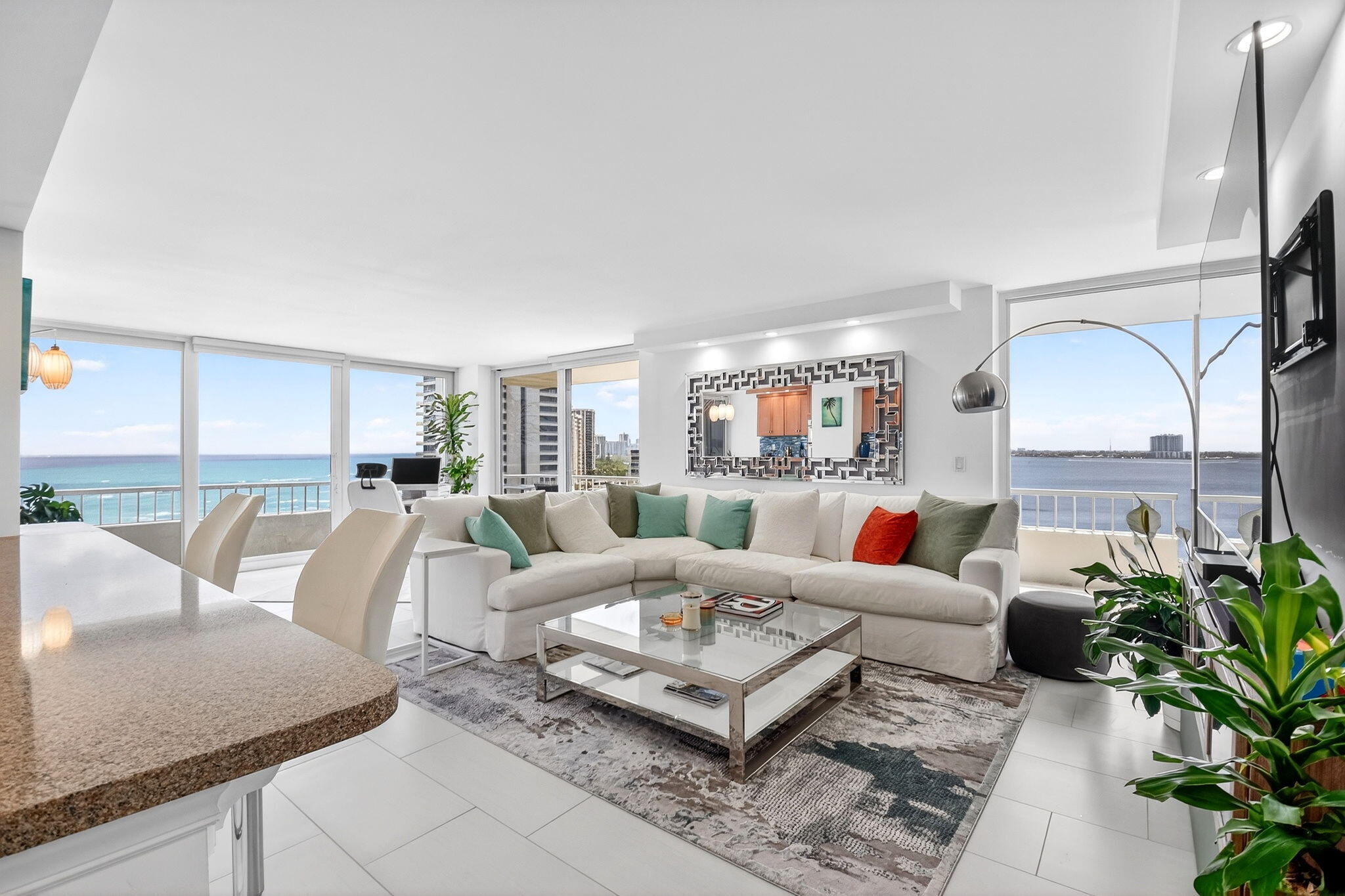5540 North Ocean Drive, Unit 9B Singer Island, FL 33404 - Photo 2 of 57 a living room with furniture potted plant and a large window