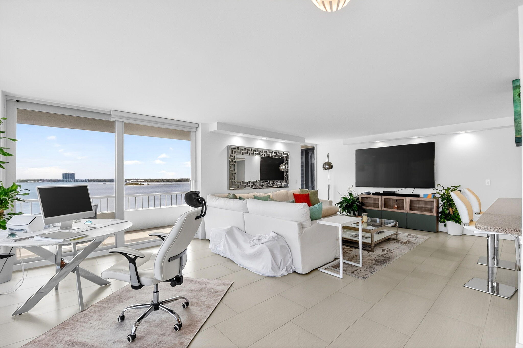 5540 North Ocean Drive, Unit 9B Singer Island, FL 33404 - Photo 21 of 57 a living room with furniture and a flat screen tv
