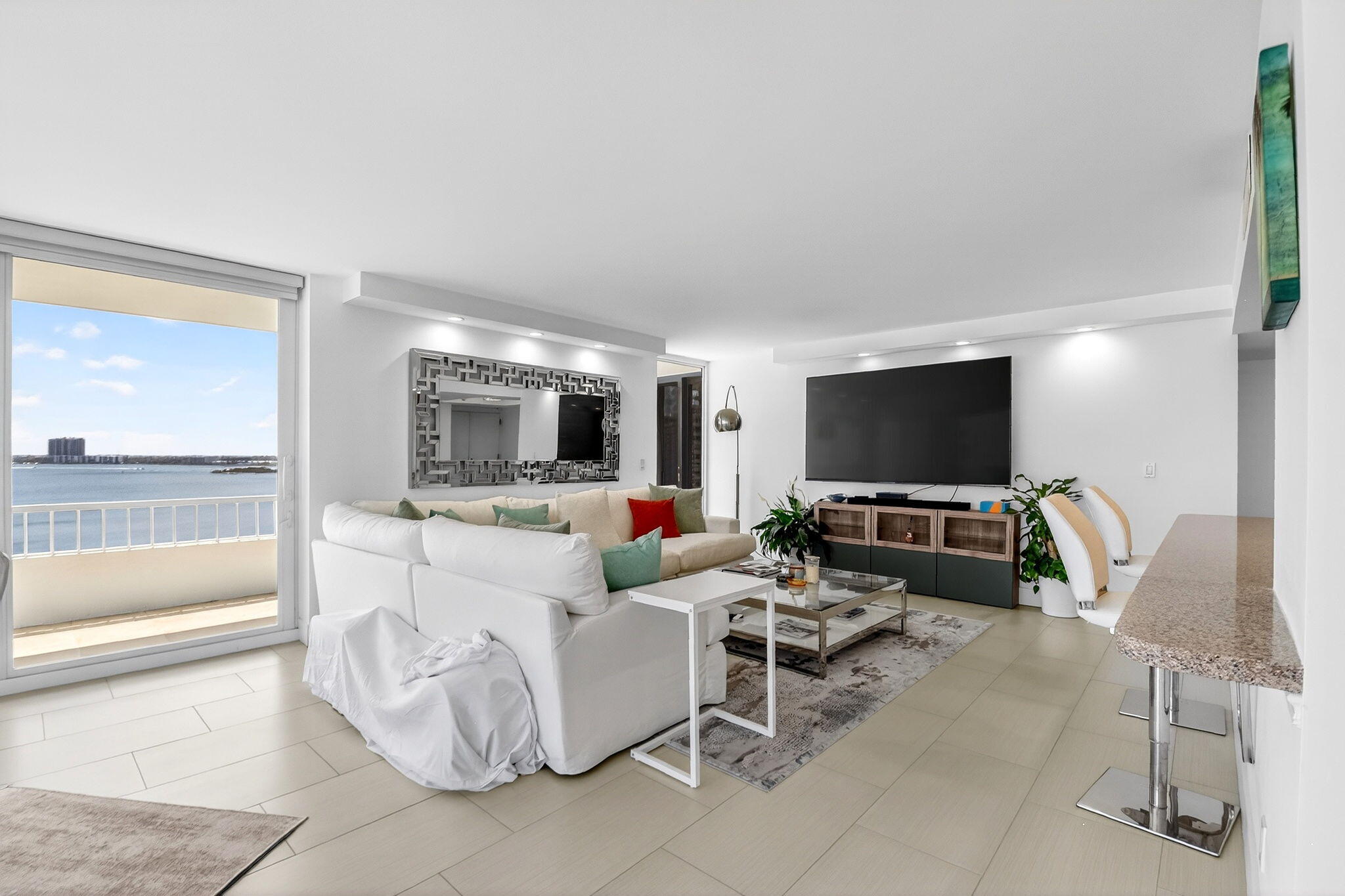 5540 North Ocean Drive, Unit 9B Singer Island, FL 33404 - Photo 24 of 57 a living room with furniture and a flat screen tv