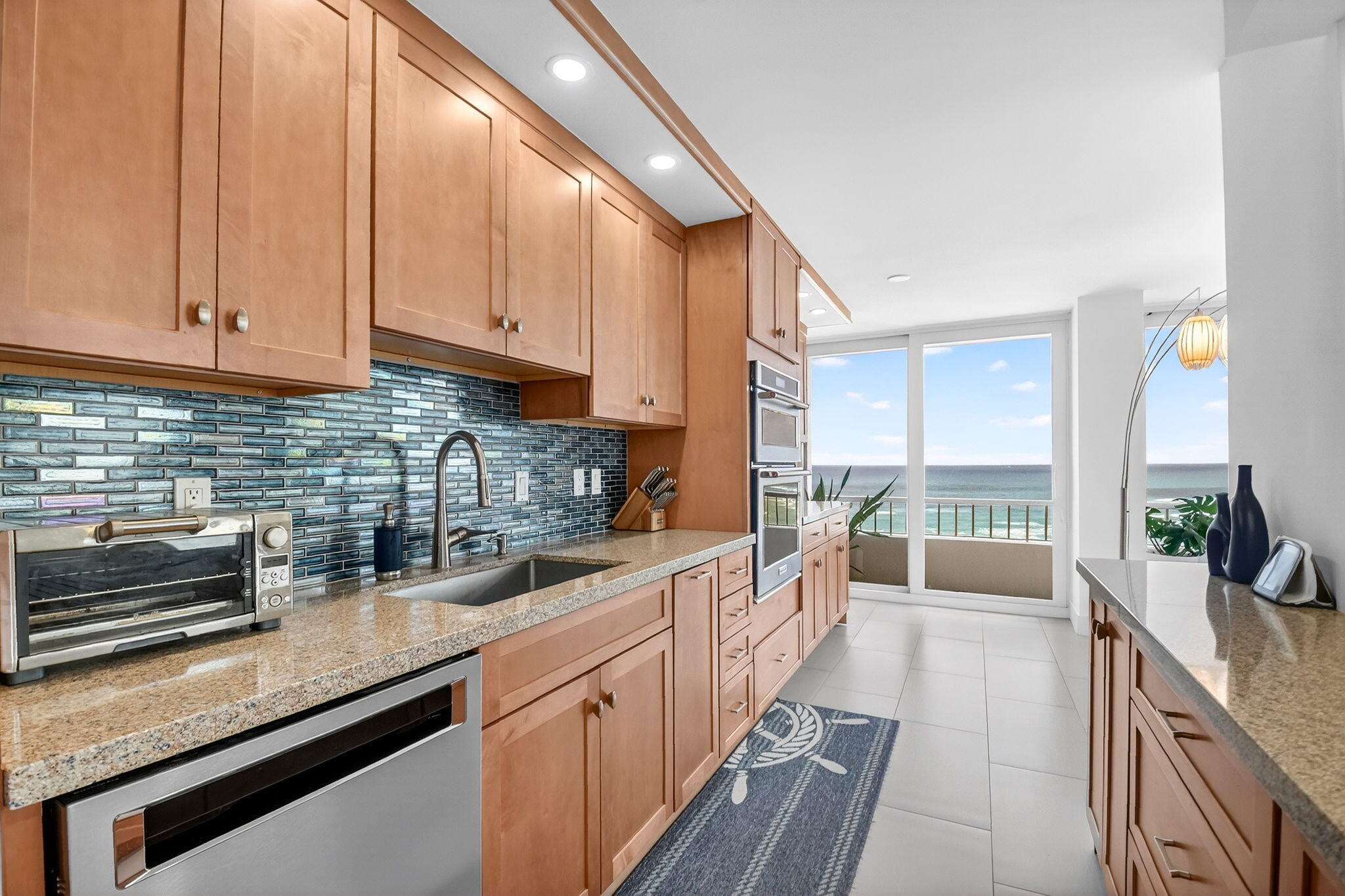 5540 North Ocean Drive, Unit 9B Singer Island, FL 33404 - Photo 4 of 57 a kitchen with stainless steel appliances granite countertop a sink a stove and cabinets