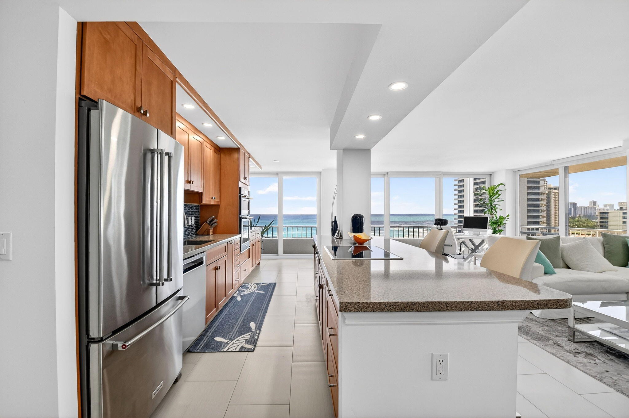 5540 North Ocean Drive, Unit 9B Singer Island, FL 33404 - Photo 5 of 57 a living room with stainless steel appliances granite countertop furniture a refrigerator a kitchen island a stove and a sink