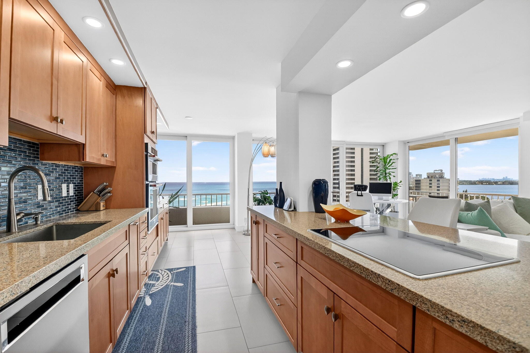 5540 North Ocean Drive, Unit 9B Singer Island, FL 33404 - Photo 6 of 57 a kitchen with granite countertop a sink dishwasher stove and cabinets