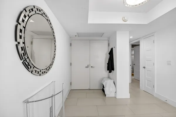 a view of a livingroom with a bathroom and a mirror
