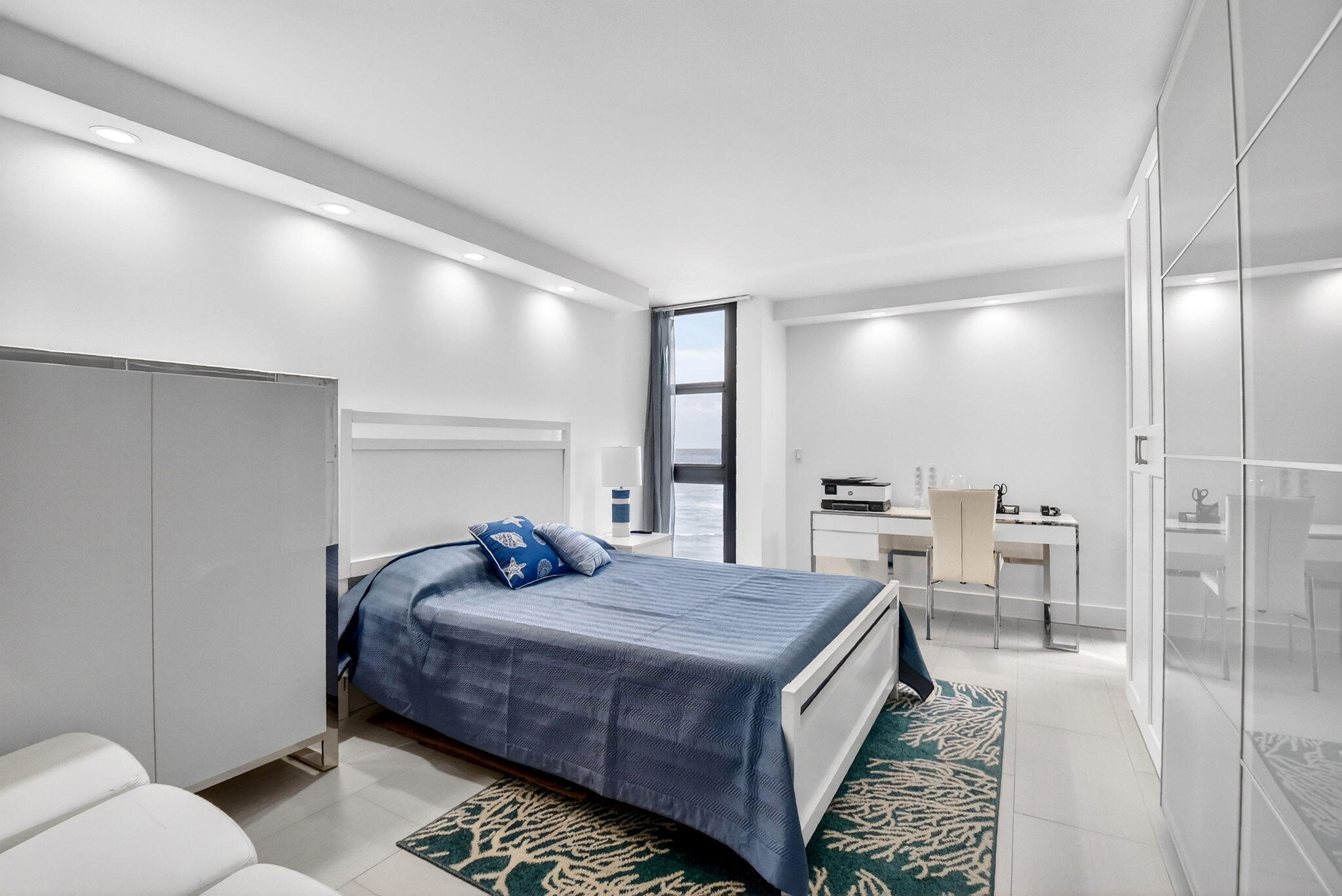 5540 North Ocean Drive, Unit 9B Singer Island, FL 33404 - Photo 9 of 57 a bedroom with a bed a table and chairs