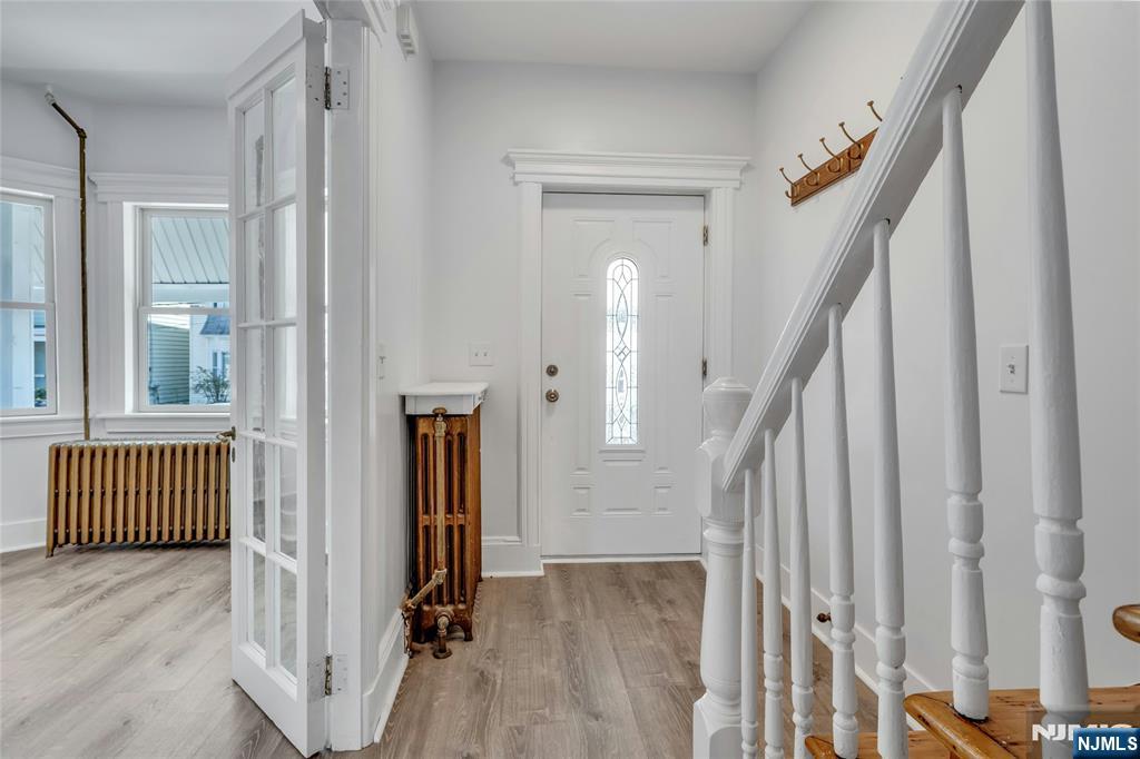 425 Hancock Place Fairview, NJ 07022 - Photo 14 of 31 a view of a hallway with wooden floor and stairs