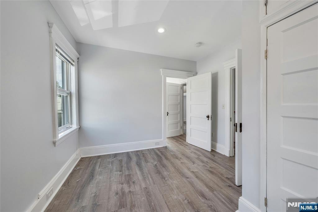 425 Hancock Place Fairview, NJ 07022 - Photo 16 of 31 a view of an empty room with wooden floor and a window