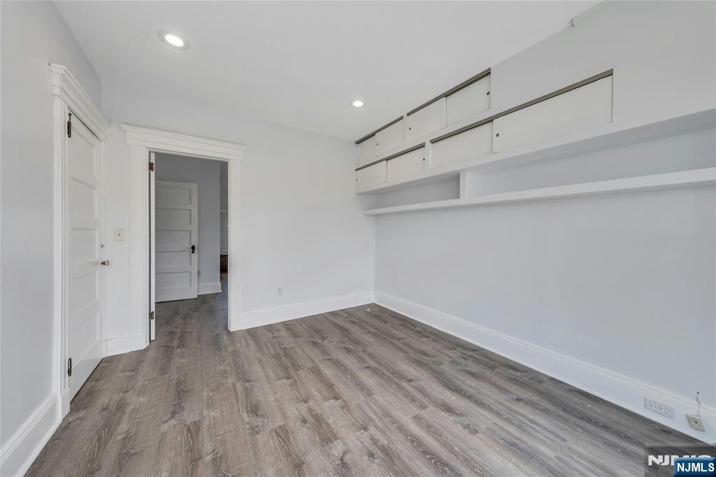 425 Hancock Place Fairview, NJ 07022 - Photo 18 of 31 a view of an empty room with wooden floor