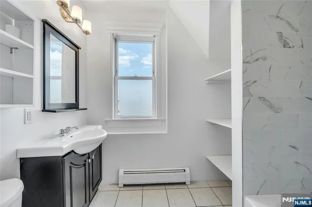 a view of a hallway and a livingroom with furniture