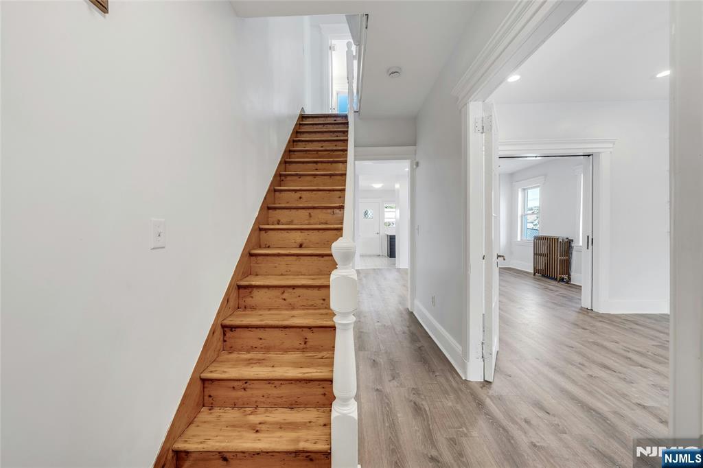 425 Hancock Place Fairview, NJ 07022 - Photo 3 of 31 a view of a hallway with wooden floor and entryway