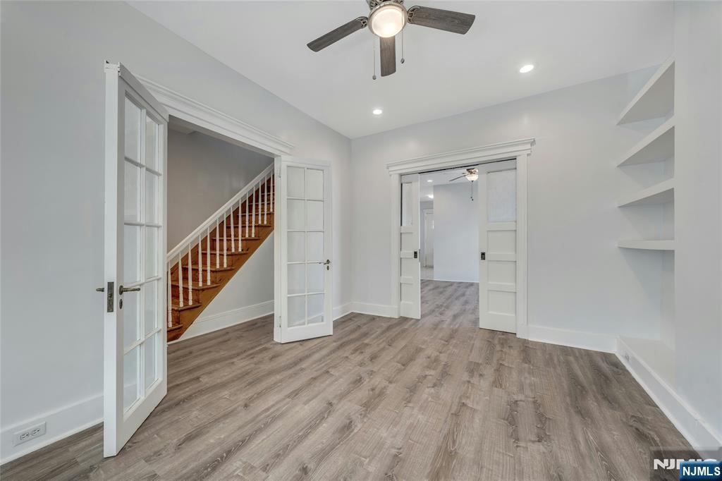 425 Hancock Place Fairview, NJ 07022 - Photo 4 of 31 wooden floor in an empty room with a gallery