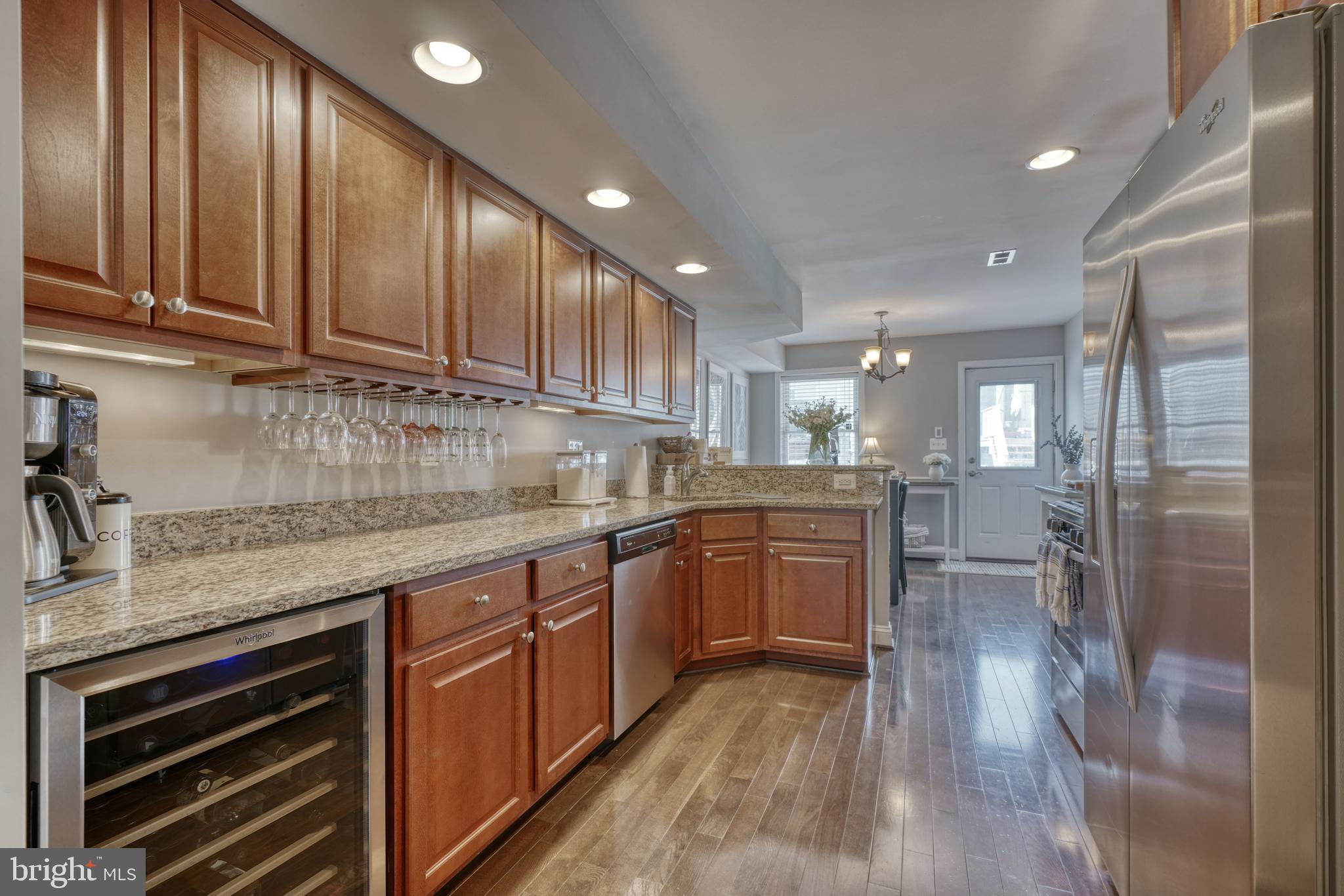 1818 Byrd Street Baltimore, MD 21230 - Photo 11 of 48 a kitchen with stainless steel appliances granite countertop wooden cabinets a sink and dishwasher