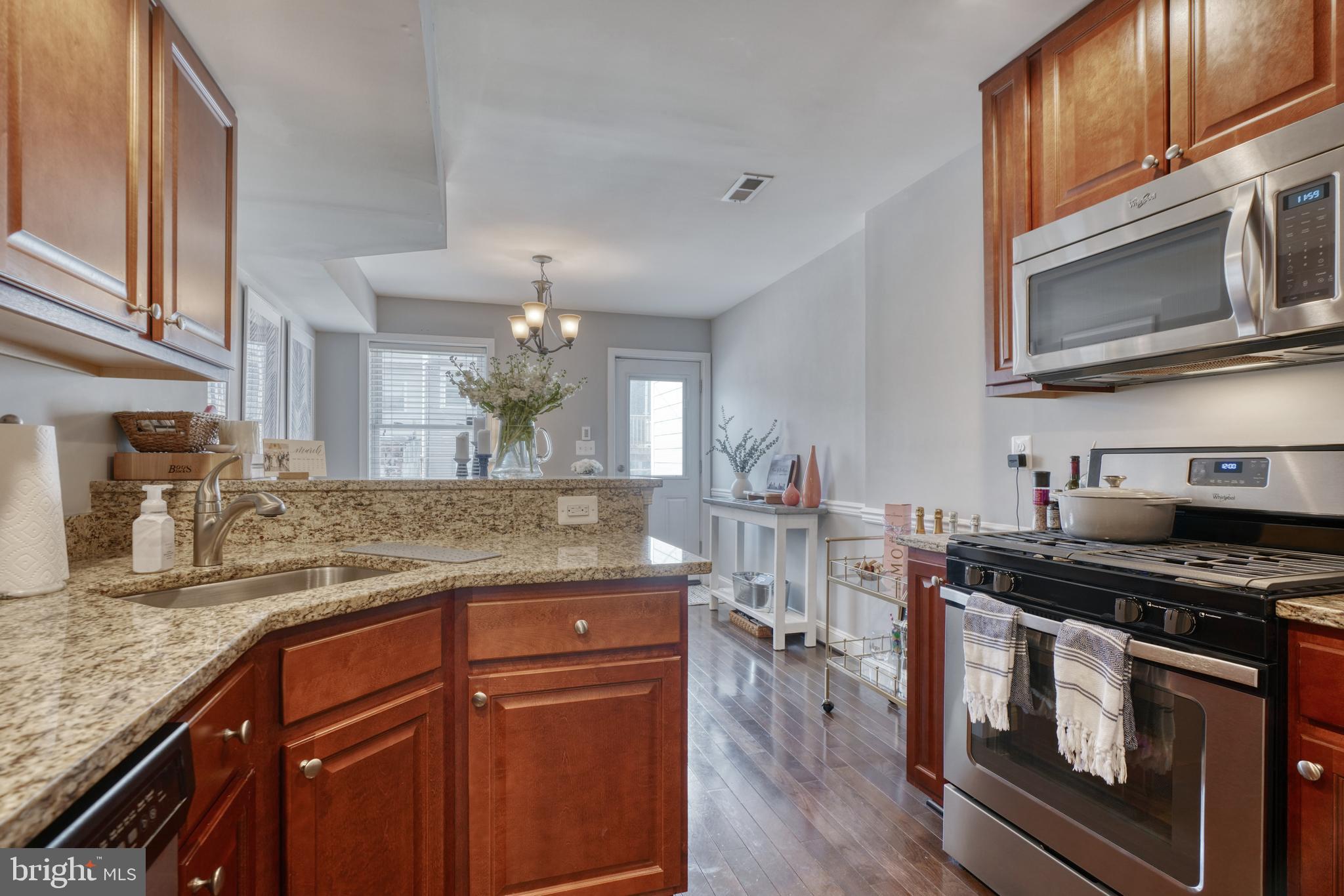 1818 Byrd Street Baltimore, MD 21230 - Photo 13 of 48 a kitchen with stainless steel appliances granite countertop a stove a sink and a microwave