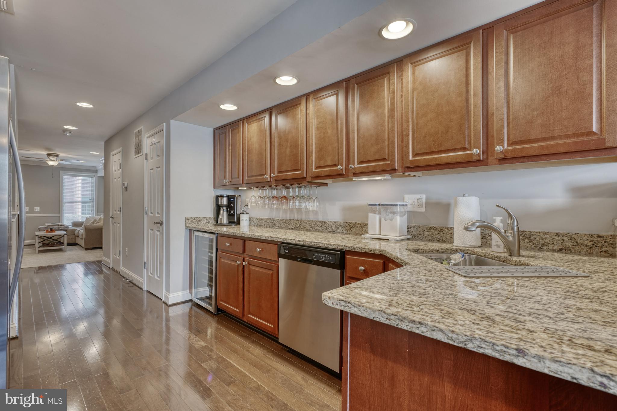 1818 Byrd Street Baltimore, MD 21230 - Photo 14 of 48 a kitchen with stainless steel appliances granite countertop wooden cabinets a sink and a stove