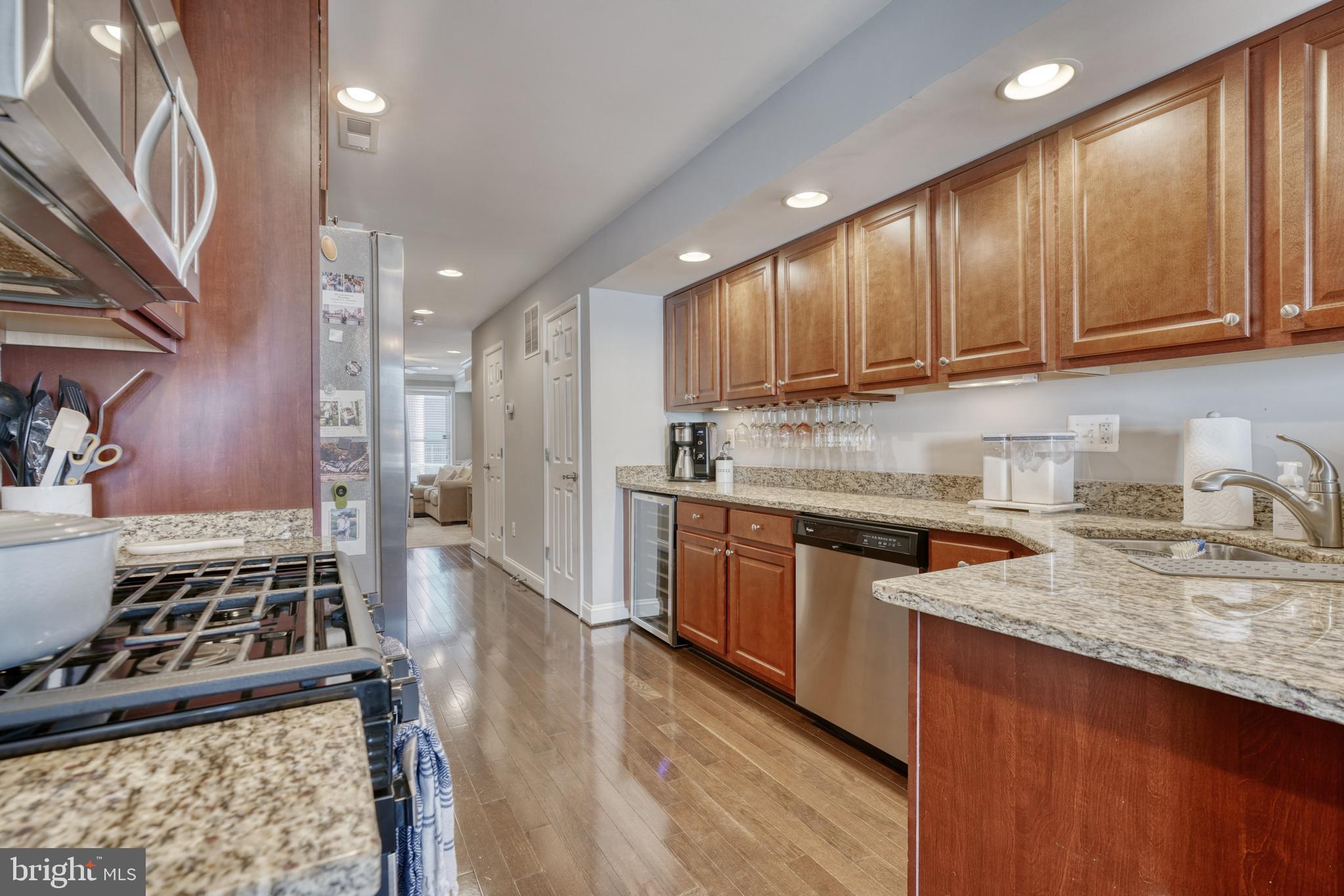 1818 Byrd Street Baltimore, MD 21230 - Photo 15 of 48 a kitchen with stainless steel appliances granite countertop a stove a sink dishwasher and cabinets with wooden floor