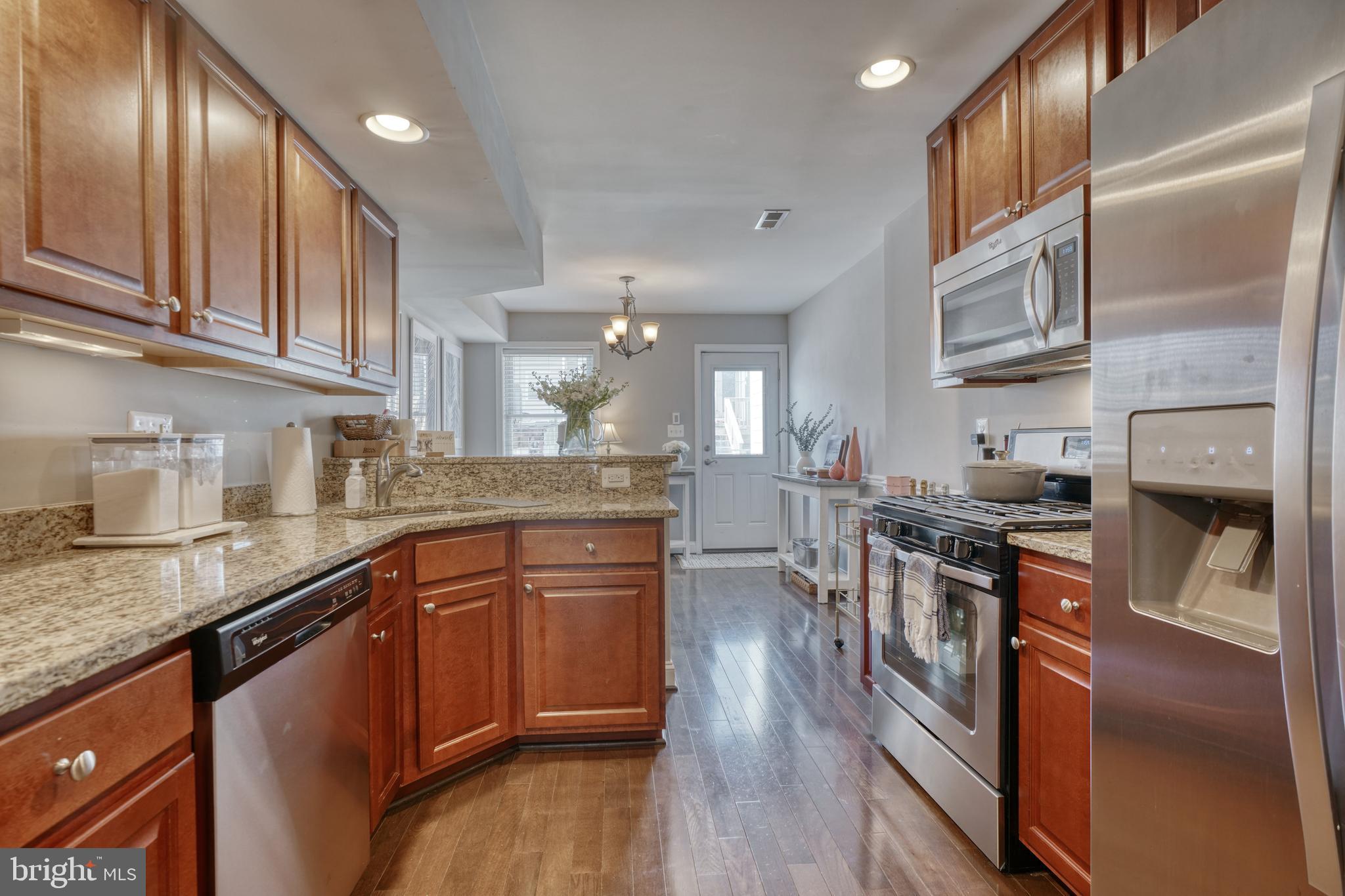 1818 Byrd Street Baltimore, MD 21230 - Photo 2 of 48 a kitchen with stainless steel appliances granite countertop a stove a sink dishwasher and a refrigerator with wooden floor