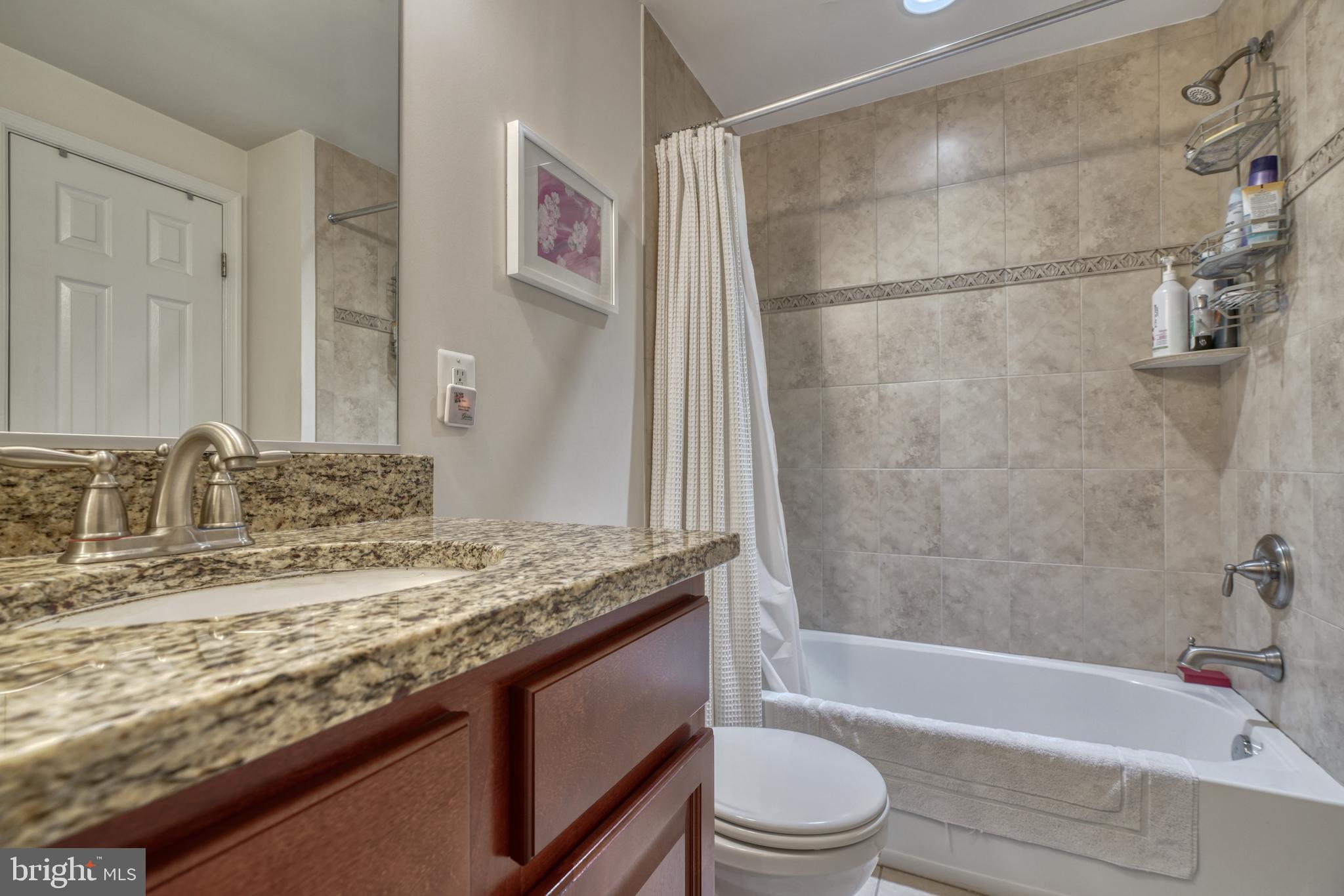 1818 Byrd Street Baltimore, MD 21230 - Photo 35 of 48 a bathroom with a granite countertop sink toilet and shower