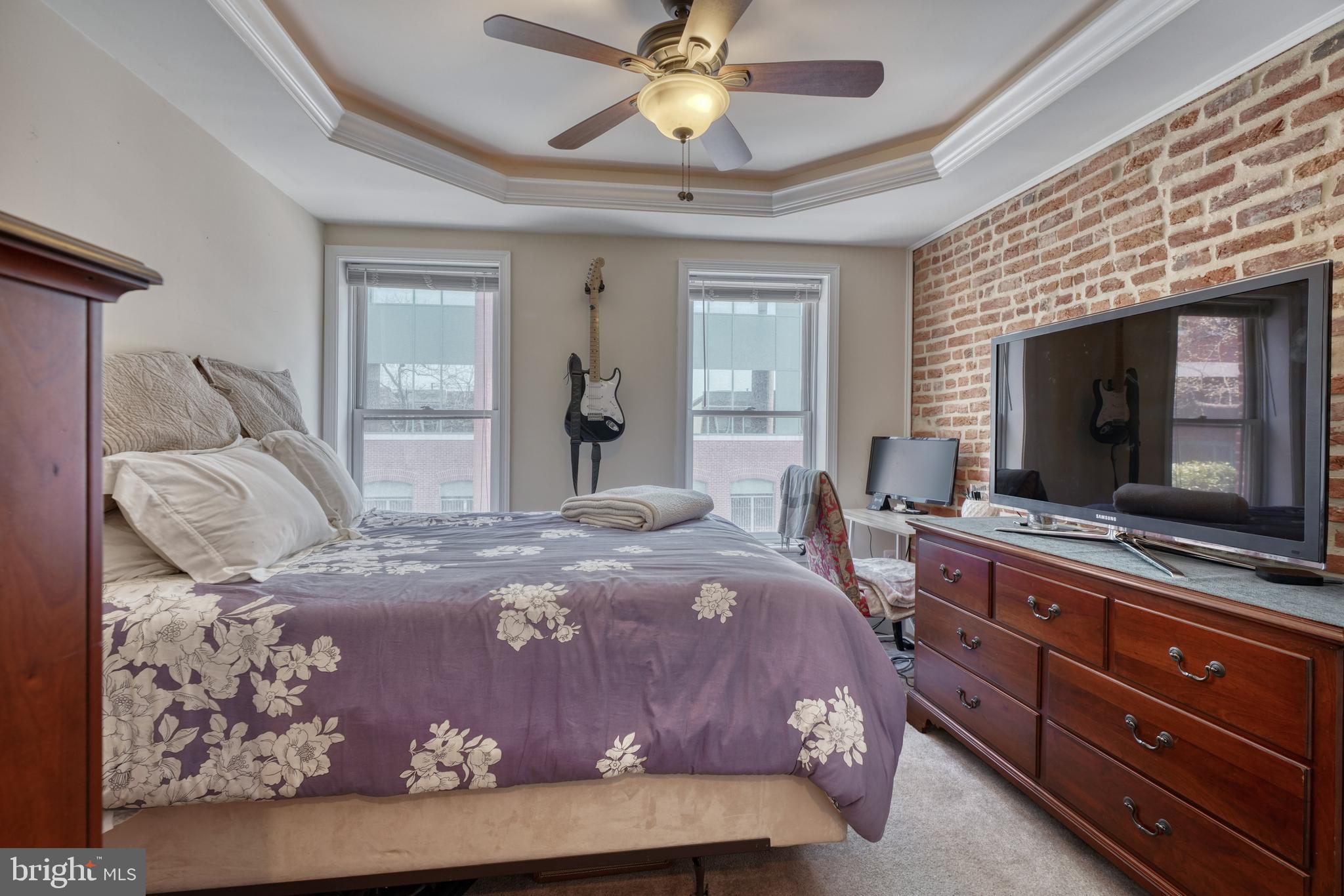 1818 Byrd Street Baltimore, MD 21230 - Photo 37 of 48 a bedroom with a bed and a flat screen tv