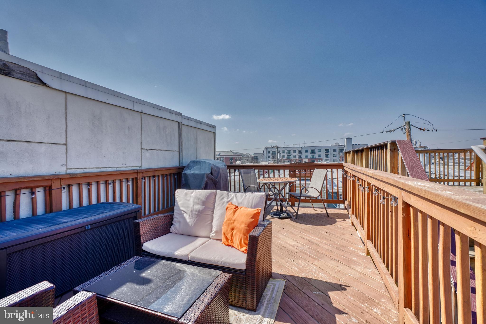1818 Byrd Street Baltimore, MD 21230 - Photo 42 of 48 a balcony with wooden floor and outdoor seating