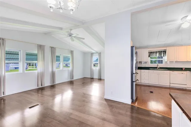 a view of a kitchen with wooden floor and a kitchen