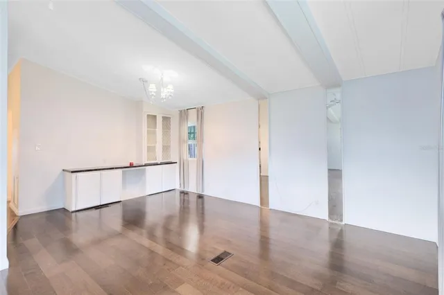 an empty room with wooden floor