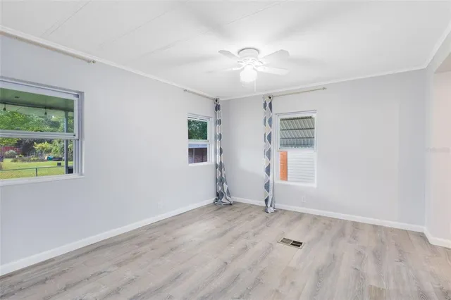 wooden floor in an empty room with a window