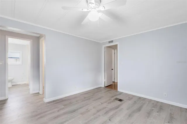 an empty room with wooden floor and door